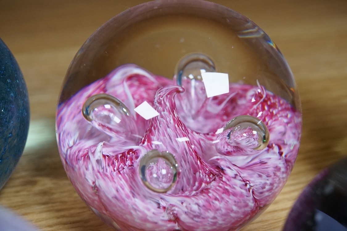 A collection of glass paperweights to include Caithness and millefiori examples, largest 10cm high